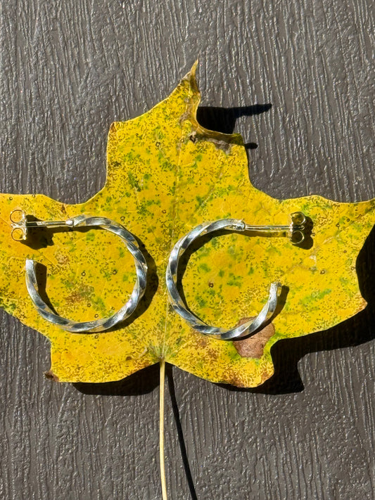 Metallic shears with a yellow Texas-shaped handle on a dark surface